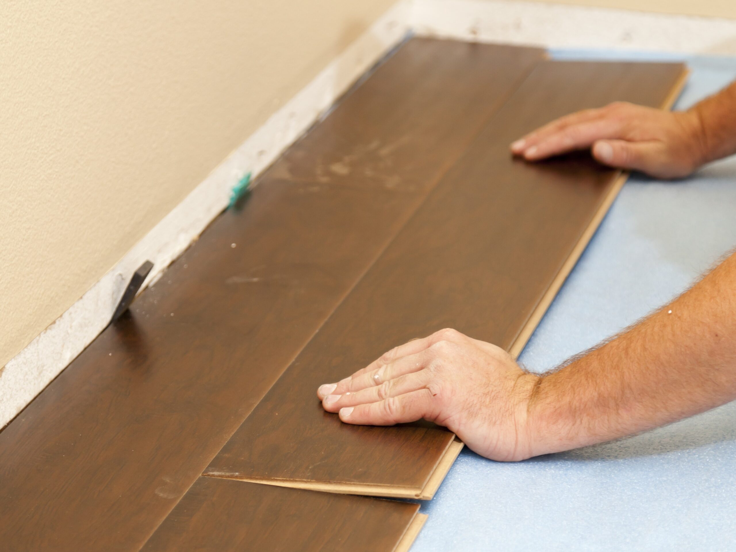 Man Installing New Laminate Wood Flooring