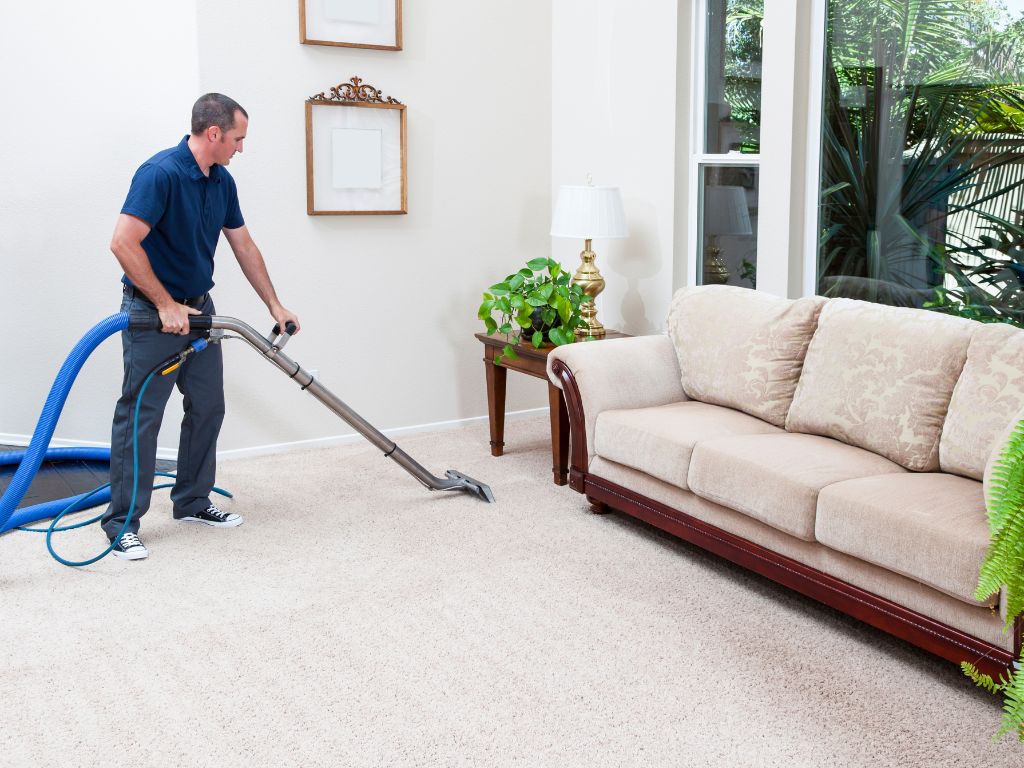 man cleaning a carpet