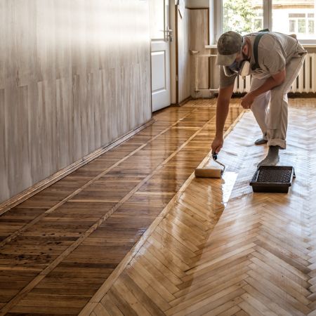 man applying floor polish